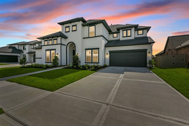 view of front facade featuring a lawn and a garage