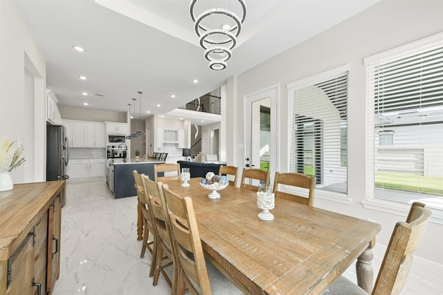 dining area featuring a notable chandelier and light tile patterned floors