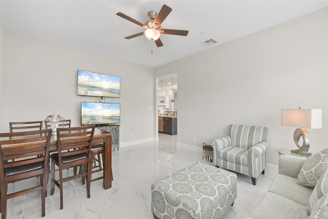 tiled living room with ceiling fan