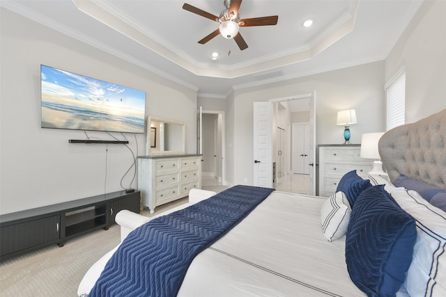 carpeted bedroom with ceiling fan, a raised ceiling, and crown molding