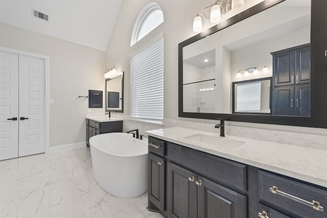 bathroom with a tub to relax in, tile patterned floors, lofted ceiling, and a healthy amount of sunlight