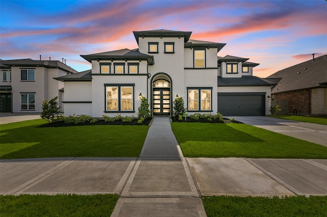 prairie-style house with a lawn and a garage