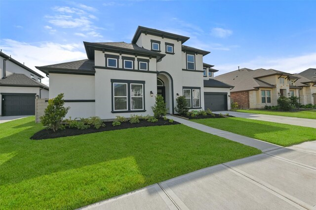 prairie-style house with a garage and a front lawn