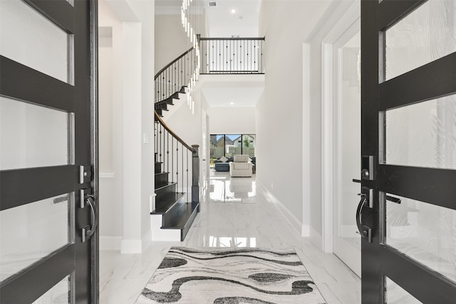 entrance foyer featuring tile patterned floors and a high ceiling