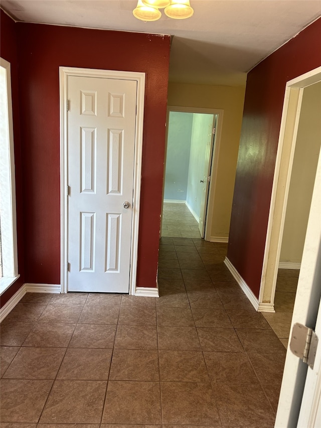 corridor featuring dark tile patterned floors