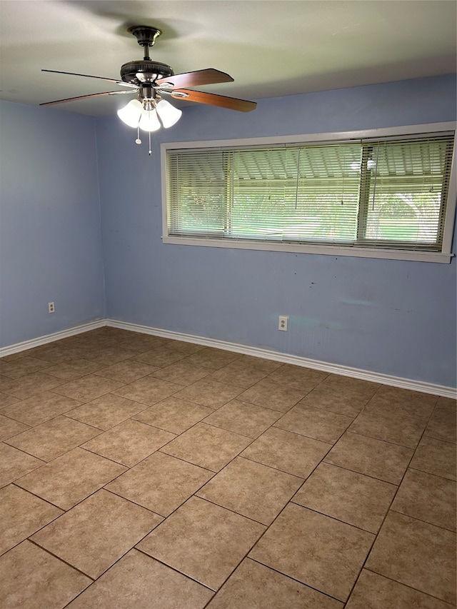 tiled spare room featuring ceiling fan and a wealth of natural light