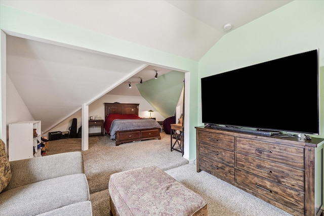 carpeted bedroom featuring lofted ceiling