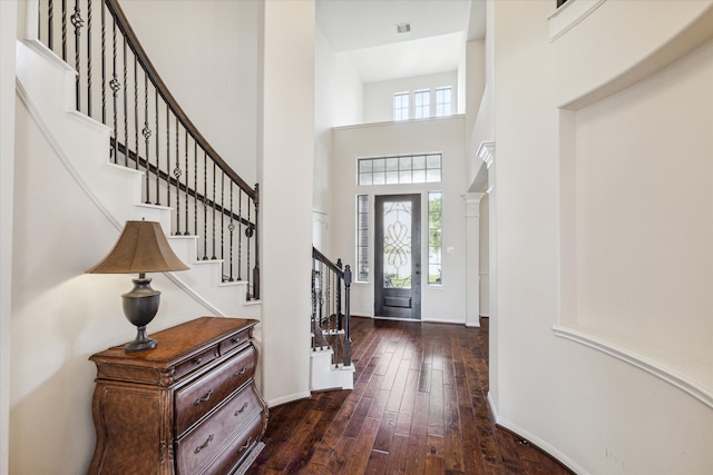 entryway featuring dark hardwood / wood-style floors and a high ceiling