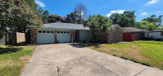 single story home with a garage, a front yard, brick siding, and fence