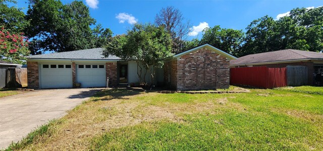 single story home featuring a front lawn and a garage