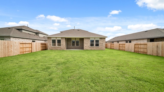 back of house featuring a lawn