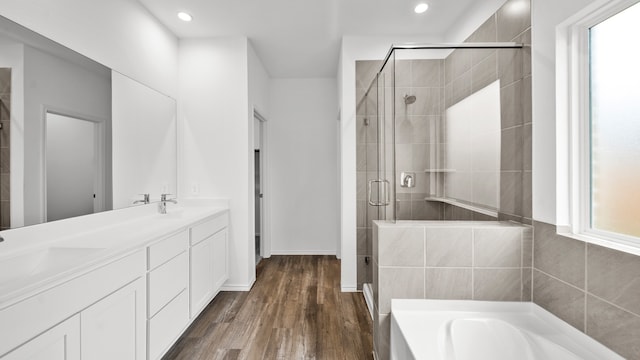 bathroom featuring vanity, wood-type flooring, and independent shower and bath