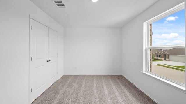 carpeted empty room featuring a healthy amount of sunlight