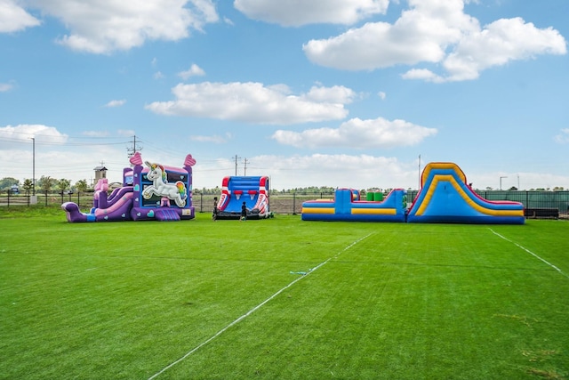 view of jungle gym featuring a lawn