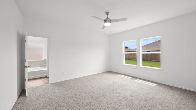 unfurnished room with ceiling fan and carpet floors