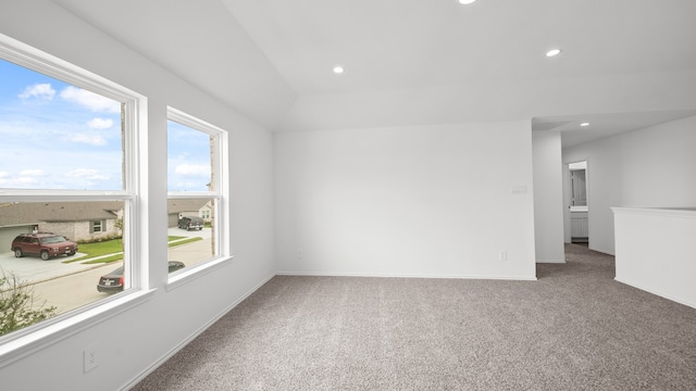 carpeted spare room featuring plenty of natural light