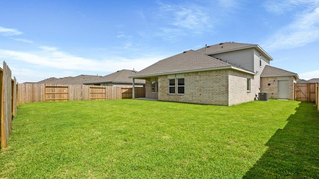 back of house featuring a yard and cooling unit