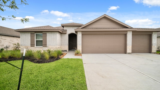 view of front of house featuring a garage and a front lawn