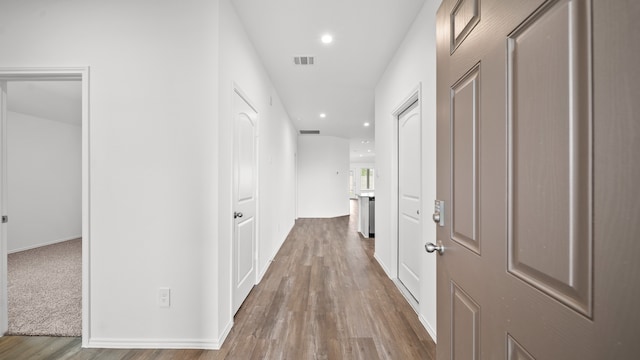 corridor with hardwood / wood-style floors