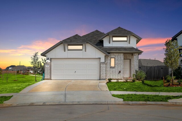 view of front facade featuring a yard and a garage