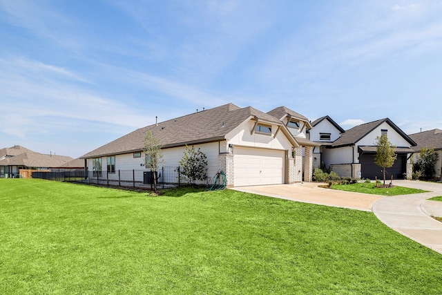 view of front of home with a front yard and a garage