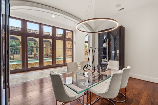 dining room featuring crown molding, plenty of natural light, and wood-type flooring