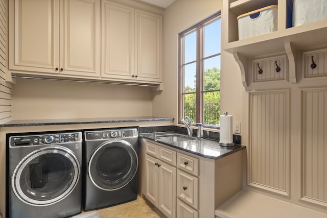 laundry area with cabinets, light tile patterned floors, independent washer and dryer, and sink