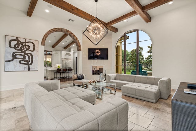 living room with a chandelier and beam ceiling