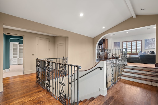 hallway with lofted ceiling with beams and hardwood / wood-style floors