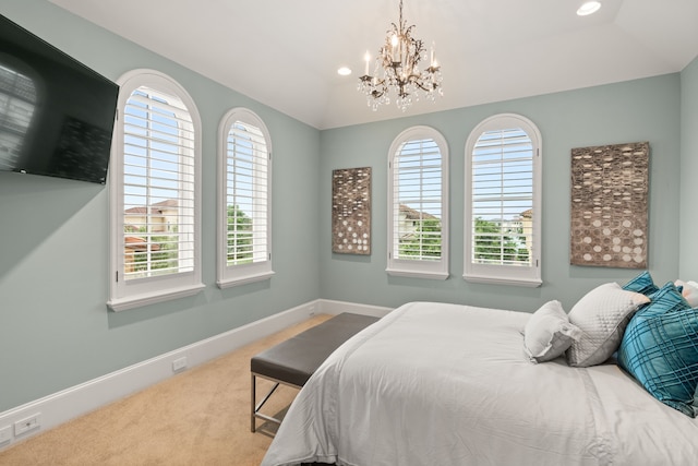 bedroom with light carpet, vaulted ceiling, and a chandelier