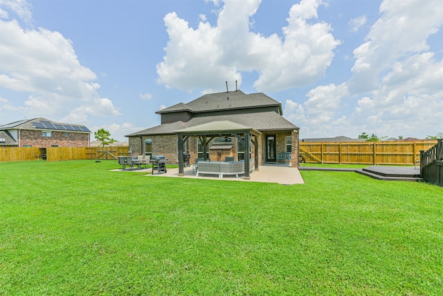 back of property with a gazebo, a yard, and a patio