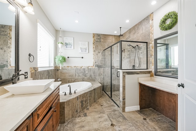 bathroom featuring shower with separate bathtub and vanity