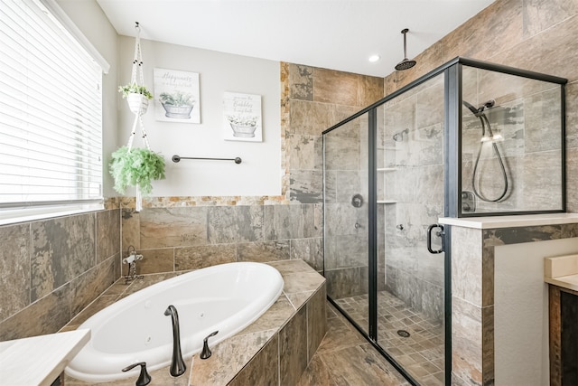 bathroom featuring separate shower and tub