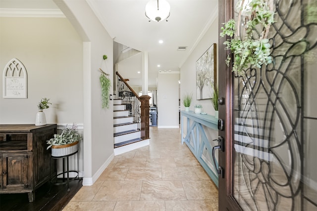 foyer entrance featuring ornamental molding