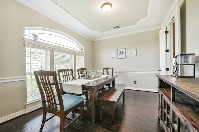 dining room with dark wood-type flooring, a wealth of natural light, and crown molding