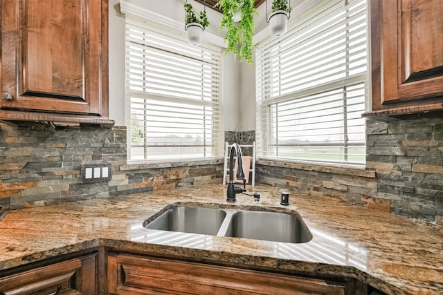 kitchen with backsplash, plenty of natural light, and sink