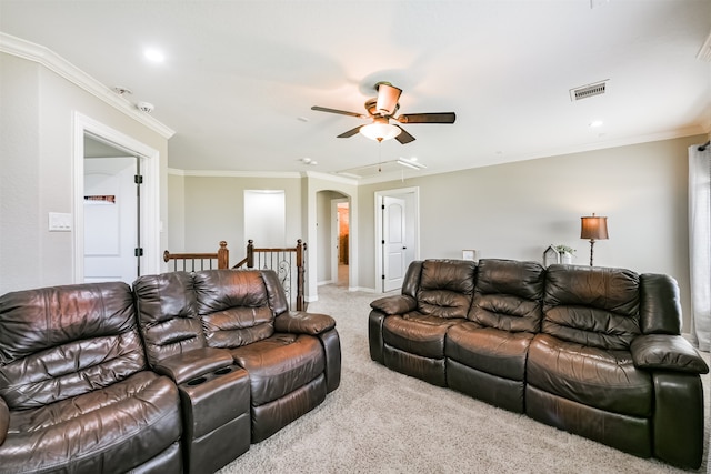 carpeted living room featuring ornamental molding and ceiling fan