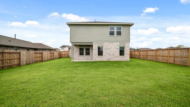 back of house featuring a lawn