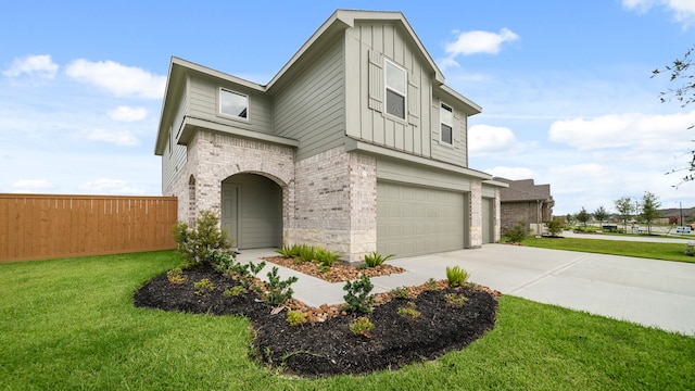 view of front of home featuring a front yard and a garage