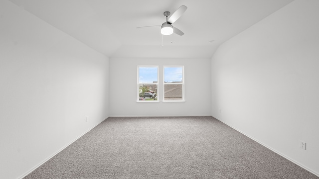 carpeted empty room with ceiling fan and lofted ceiling