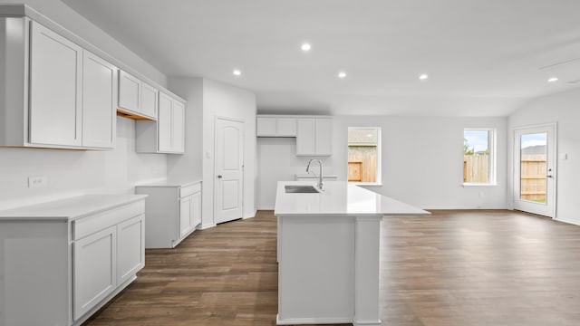 kitchen with white cabinets, sink, an island with sink, and dark hardwood / wood-style floors