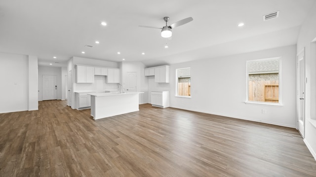 unfurnished living room featuring light wood-type flooring and ceiling fan