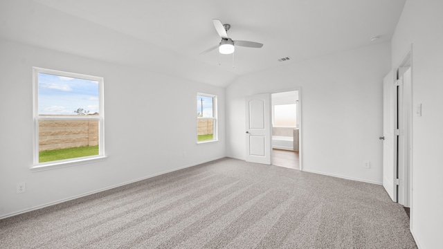 unfurnished bedroom with light carpet, multiple windows, lofted ceiling, and ceiling fan