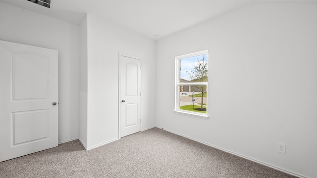 unfurnished bedroom featuring light carpet and a closet