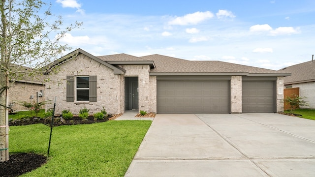 view of front of property with a front yard and a garage