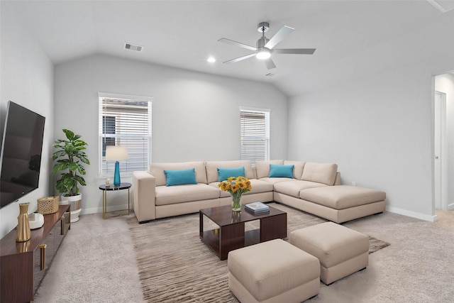 carpeted living room with ceiling fan and lofted ceiling