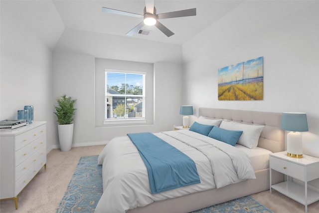 bedroom with light colored carpet, ceiling fan, and lofted ceiling