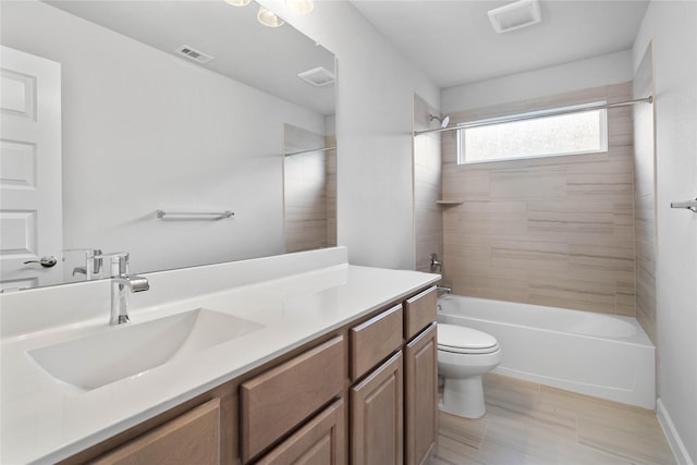 full bathroom with vanity, tiled shower / bath combo, and toilet