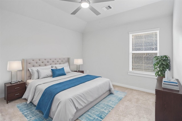 bedroom with ceiling fan, light colored carpet, and vaulted ceiling