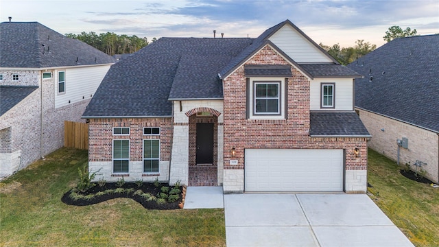 view of front of home featuring a garage and a lawn